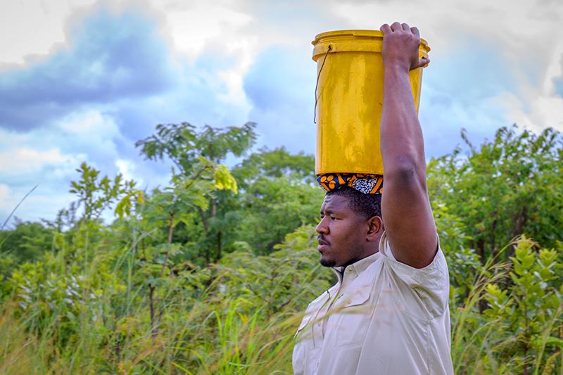 Kelvin Beachum carrying water in Lusaka, Zambia