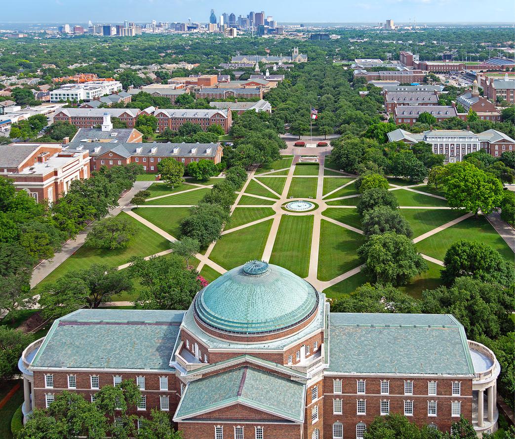 Drone-captured flyover image of the SMU campus, know as The Hilltop. The Dallas city skyline is located just south of the campus.