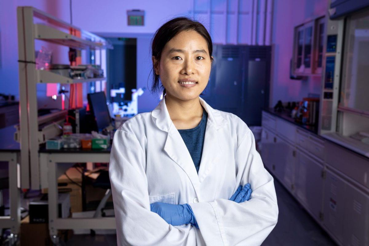 Khengdauliu Chawang ’24, a Ph.D. student in electrical and computer engineering at the Lyle School of Engineering, posing for a picture while wearing a white researcher's labcoat