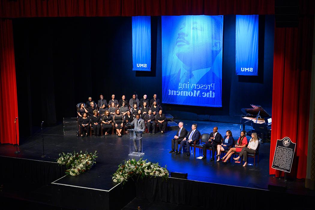 People gathered on stage at Mcfarlin Auditorium to commemorate the plaque dedication for Dr. Martin Luther King Jr.