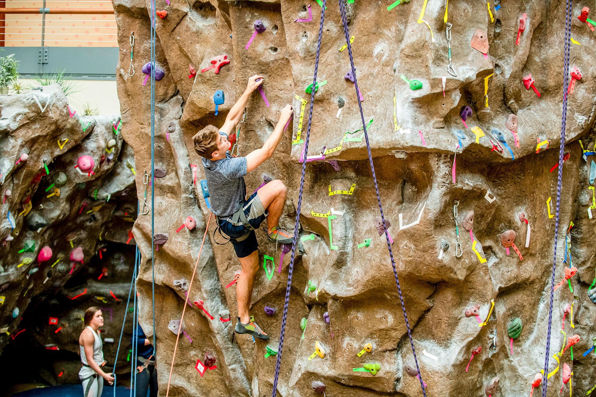 student on the climbing wall in dedman center for lifetime sports